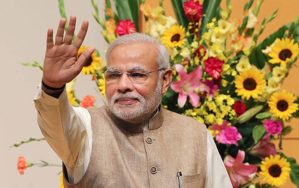 Indian Prime Minister Narendra Modi waves after his lecture at the University of the Sacred Heart in Tokyo.