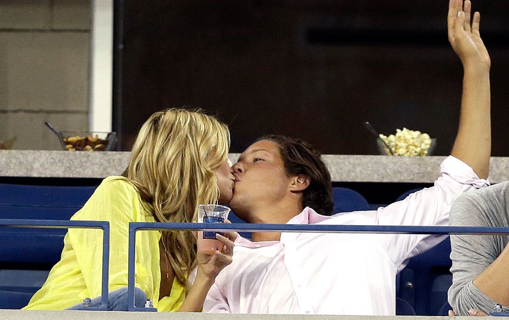 Heidi Klum kisses Vito Schnabel during a match between Victoria Azarenka, of Belarus, and Aleksandra Krunic, of Serbia, during the fourth round of the 2014 US Open Tennis Tournament.