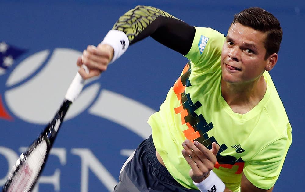 Milos Raonic, of Canada, serves to Kei Nishikori, of Japan, during the fourth round of the US Open tennis tournament.