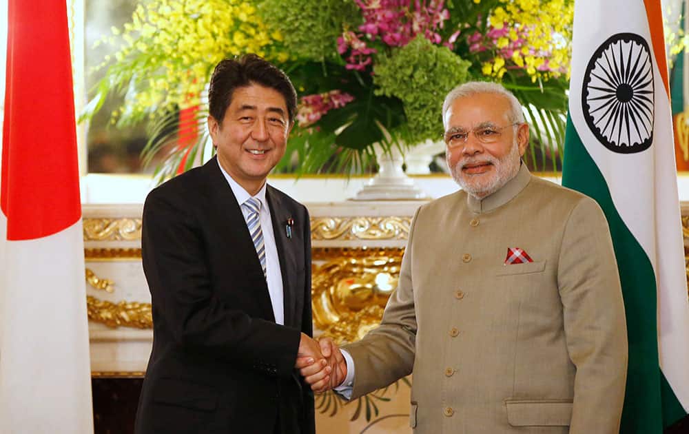 Prime Minister Narendra Modi, right, and Japan's Prime Minister Shinzo Abe shake hands before their talks at the state guest house in Tokyo.