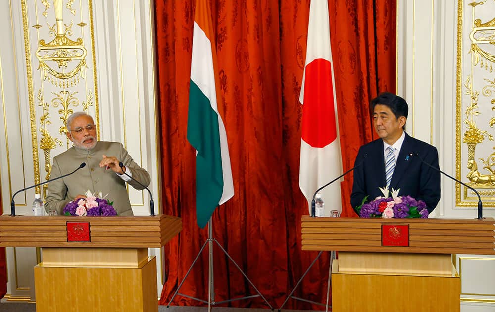 Prime Minister Narendra Modi, left, speaks with Japanese Prime Minister Shinzo Abe during a Japan-India Joint press conference at Akasaka State Guesthouse in Tokyo.