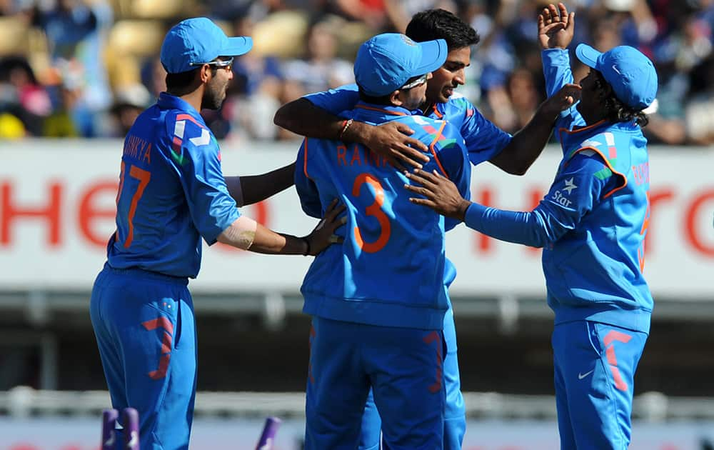 Bhuvneshwar Kumar is congratulated by teammates after bowling England's Alex Hales for six runs during the fourth One Day International cricket match between England and India at Edgbaston cricket ground, Birmingham, England.