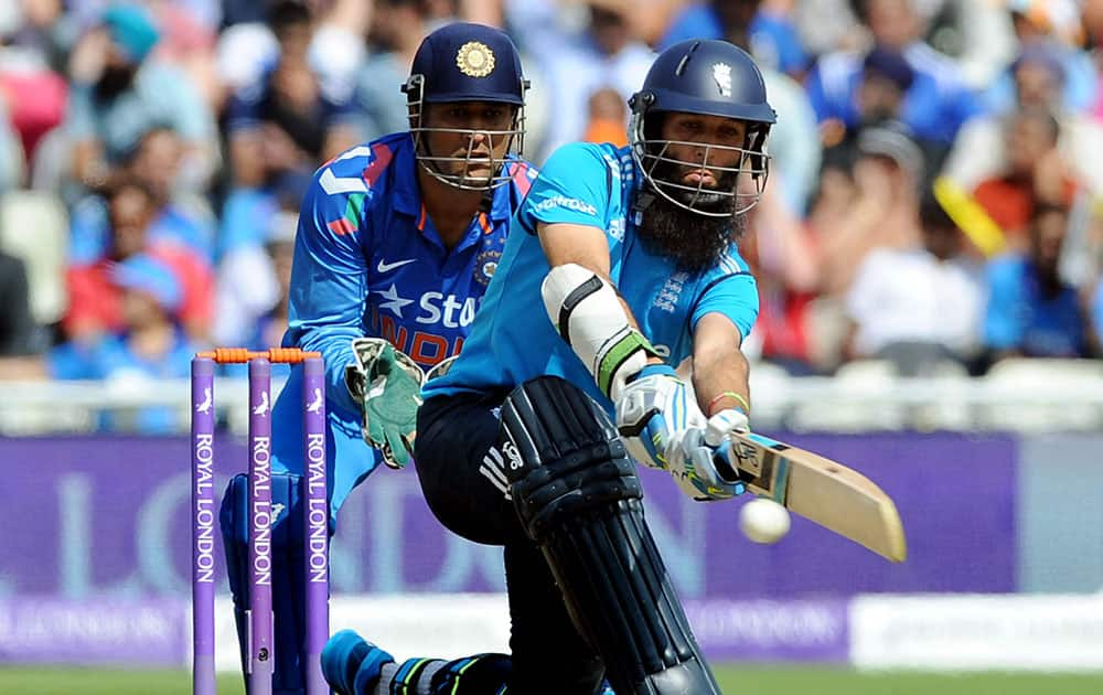 England's Moeen Ali plays a shot watched India's wicket keeper and captain M S Dhoni during the fourth One Day International match between England and India at Edgbaston cricket ground, Birmingham.