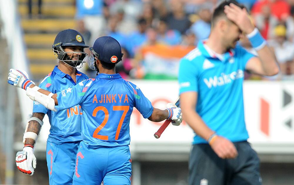 Shikhar Dhawan celebrates with Ajinkya Rahane after scoring half century during the fourth One Day International match between England and India at Edgbaston cricket ground, Birmingham, England.