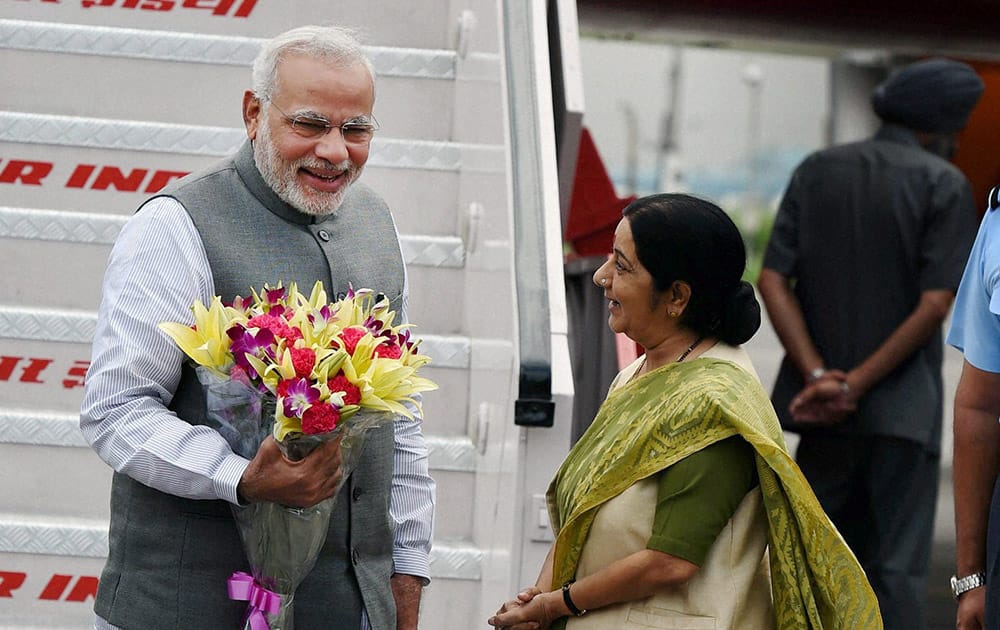 Prime Minister Narendra Modi being welcomed by Foreign Minister Sushma Swaraj upon his arrival at AFS Palam in New Delhi.