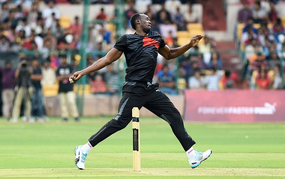 Olympic gold medalist sprinter Usain Bolt bowls during a friendly cricket match in Bengaluru.