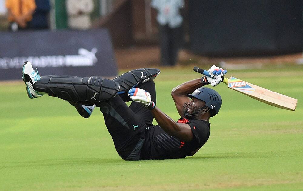 Olympic Gold Medalist sprinter Usain Bolt celebrates his team's victory in a friendly cricket match in Bengaluru.