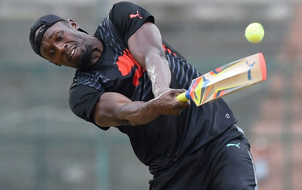 Olympic gold medalist sprinter Usain Bolt hits a six leading his team to a victory in a friendly cricket match in Bengaluru.