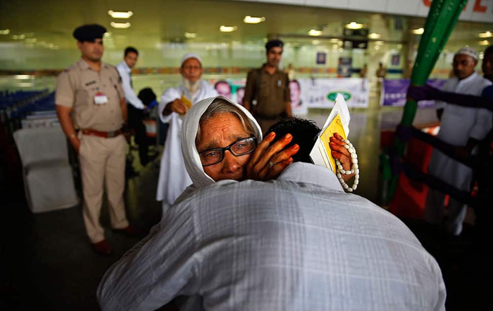 A Muslim woman pilgrim cries as she hugs her son at the airport before leaving for the annual hajj pilgrimage to the holy city of Mecca in New Delhi, India.