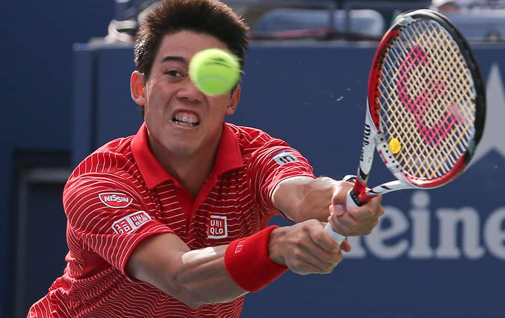 Kei Nishikori, of Japan, returns a shot against Stan Wawrinka, of Switzerland, during the quarterfinals of the 2014 US Open tennis tournament.