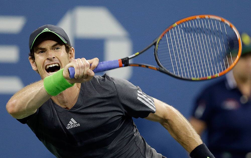 Andy Murray, of Britain, returns a shot to Novak Djokovic, of Serbia, during the quarterfinals of the US Open tennis tournament.