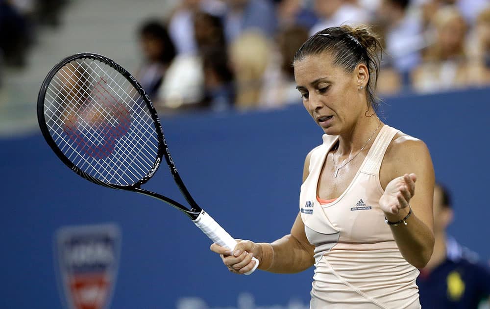 Flavia Pennetta, of Italy, reacts after missing a shot against Serena Williams, of the United States, during the quarterfinals of the US Open tennis tournament.