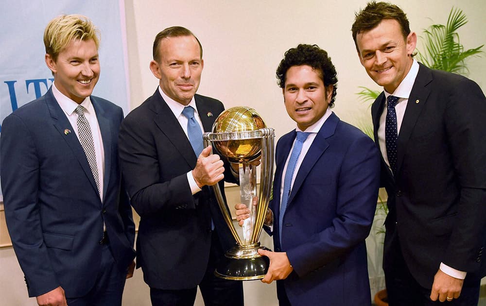 Australian Prime Minister Tony Abbott and legendary cricketer Sachin Tendulkar flanked by former Australian cricketers Adam Gilchrist and Brett Lee pose with the Cricket World Cup trophy during a sporting event organised by Australian Consulate at Cricket Club of India (CCI) in Mumbai.