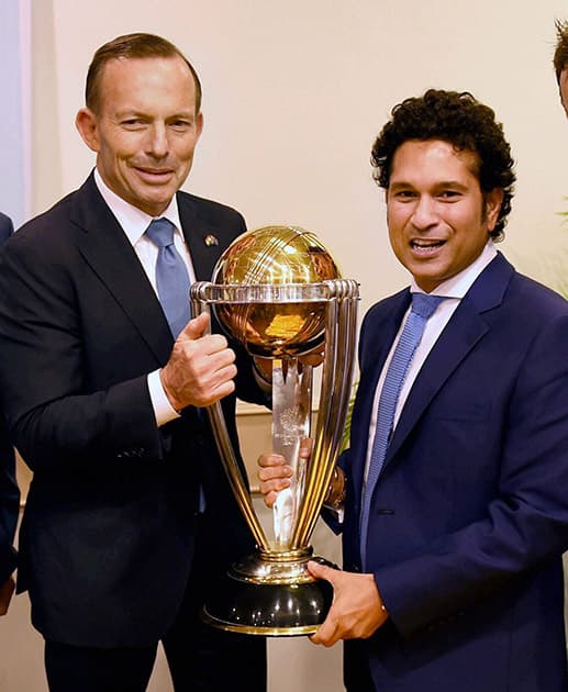 Australian Prime Minister Tony Abbott and legendary cricketer Sachin Tendulkar pose with the Cricket World Cup trophy during a sporting event organised by Australian Consulate at Cricket Club of India (CCI) in Mumbai.