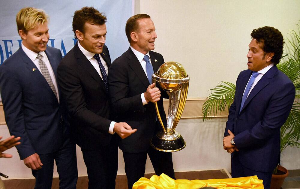 Australian Prime Minister Tony Abbott, legendary cricketer Sachin Tendulkar and former Australian cricketers Adam Gilchrist and Brett Lee with the Cricket World Cup trophy during a sporting event organised by Australian Consulate at Cricket Club of India (CCI) in Mumbai.