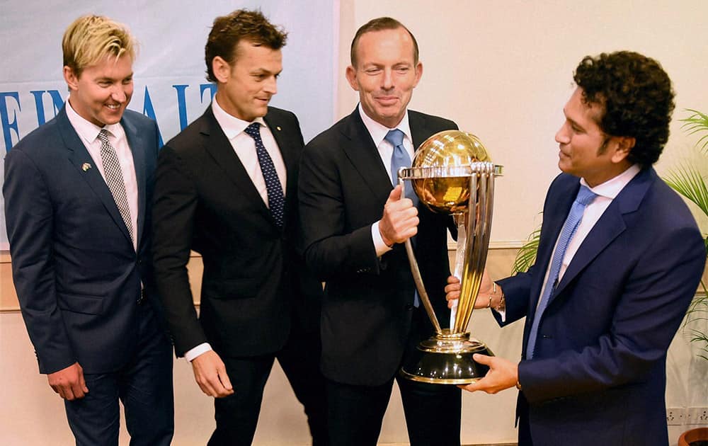 Australian Prime Minister Tony Abbott, legendary cricketer Sachin Tendulkar and former Australian cricketers Adam Gilchrist and Brett Lee with the Cricket World Cup trophy during a sporting event organised by Australian Consulate at Cricket Club of India (CCI) in Mumbai.