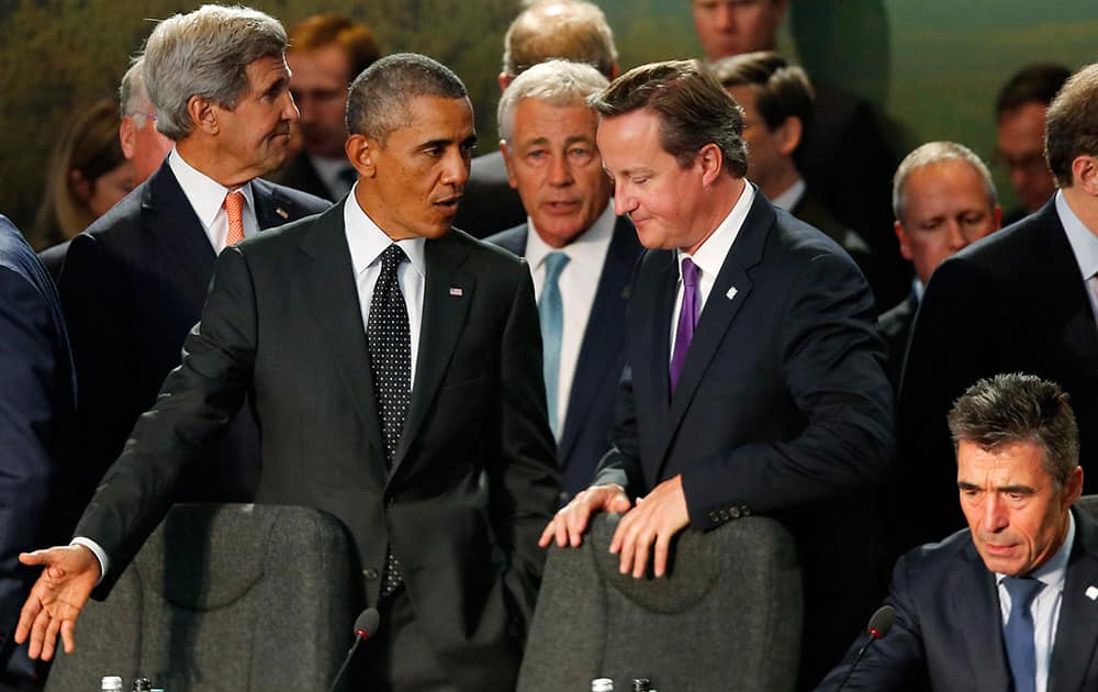 President Barack Obama speaks with British Prime Minister David Cameron as NATO leaders meet regarding Afghanistan at the NATO summit at Celtic Manor in Newport, Wales.