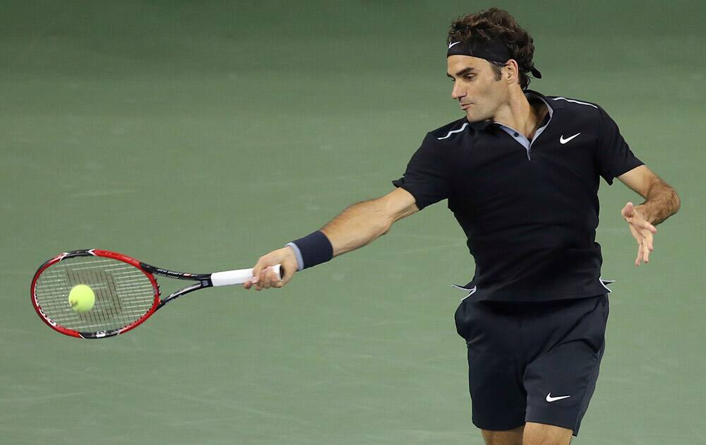 Roger Federer, of Switzerland, returns a shot to Gael Monfils, of France, during the quarterfinals of the US Open tennis tournament.