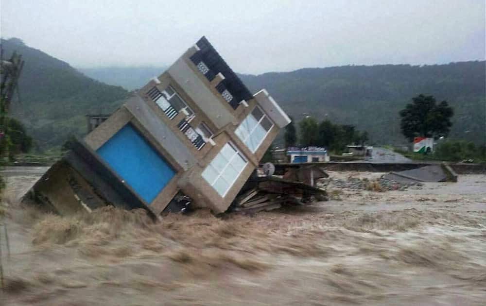 A building collapses due to flash floods triggered by heavy rains in Poonch.