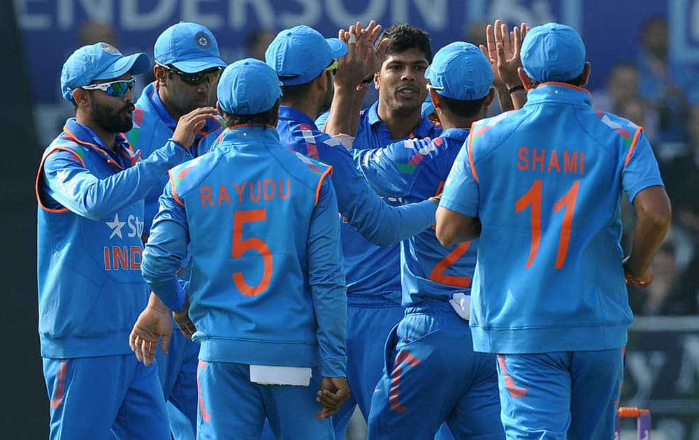 Umesh Yadav is congratulated by team after bowling England's Alex Hales caught Ajinkya Rahane for 4 runs during the fifth One Day International match between England and India at Headingley cricket ground, Leeds, England.