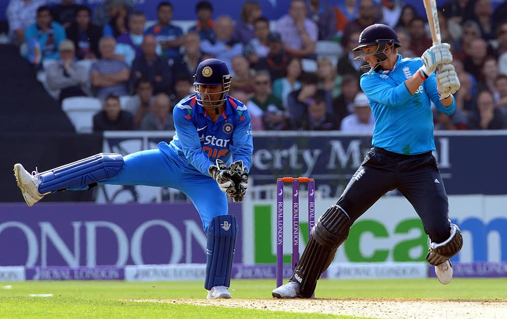 England's Joe Root, right, plays a shot past India's wicket keeper M S Dhoni during the fifth One Day International match between England and India at Headingley cricket ground, Leeds.