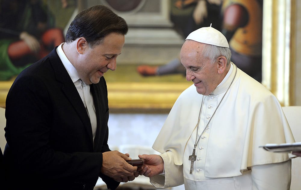 Pope Francis and Panama's President Juan Carlos Varela exchange gifts on the occasion of their meeting in the Apostolic Palace at the Vatican.