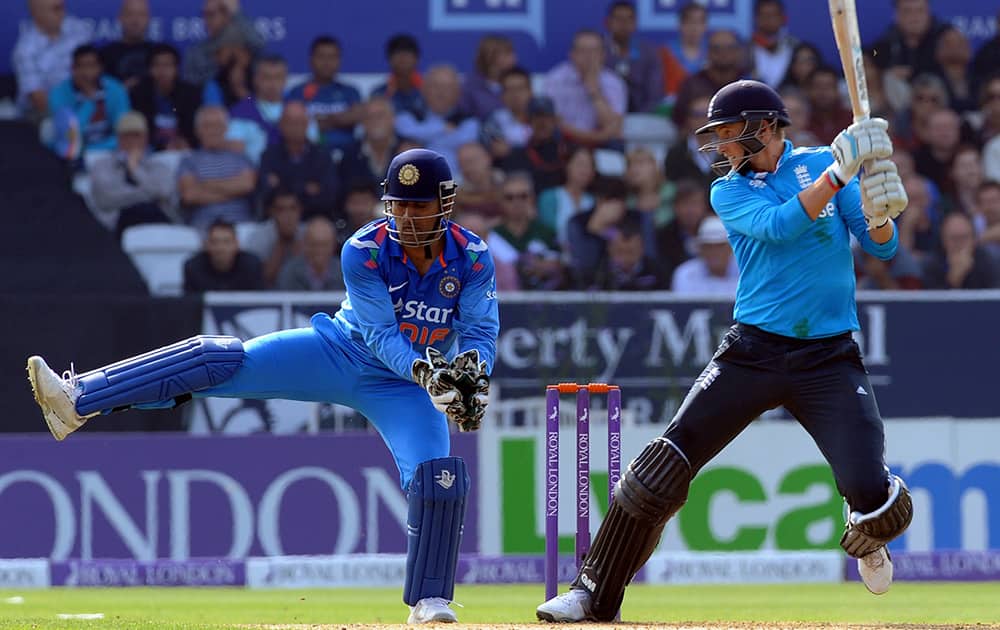 England's Joe Root plays a shot past India's wicket keeper M S Dhoni during the fifth One Day International match between England and India at Headingley cricket ground, Leeds, England.