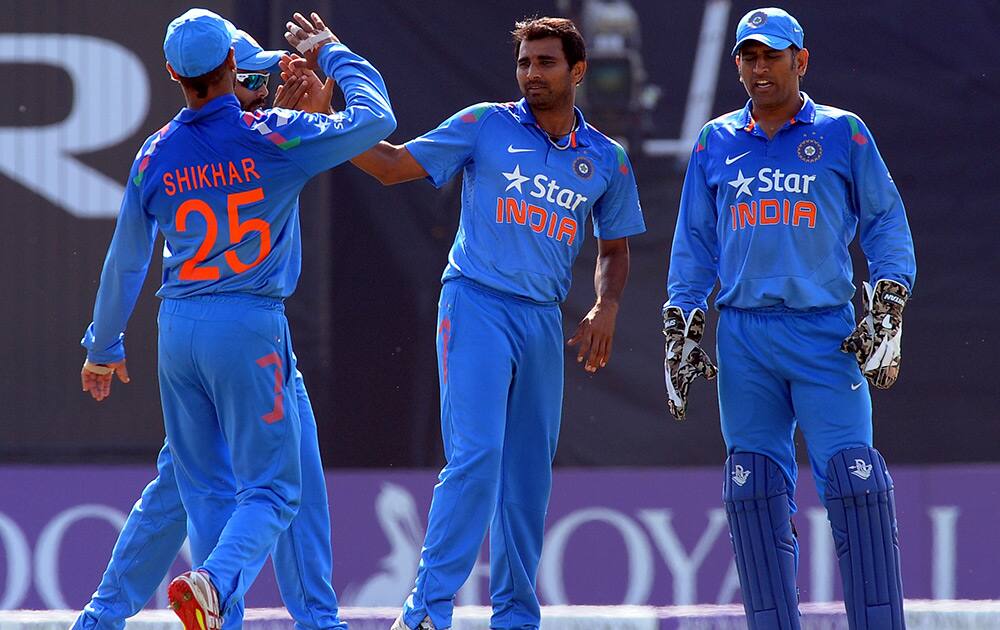 Mohammed Shami celebrates after bowling England's Chris Woakes for 9 runs during the fifth One Day International match between England and India at Headingley cricket ground, Leeds, England.