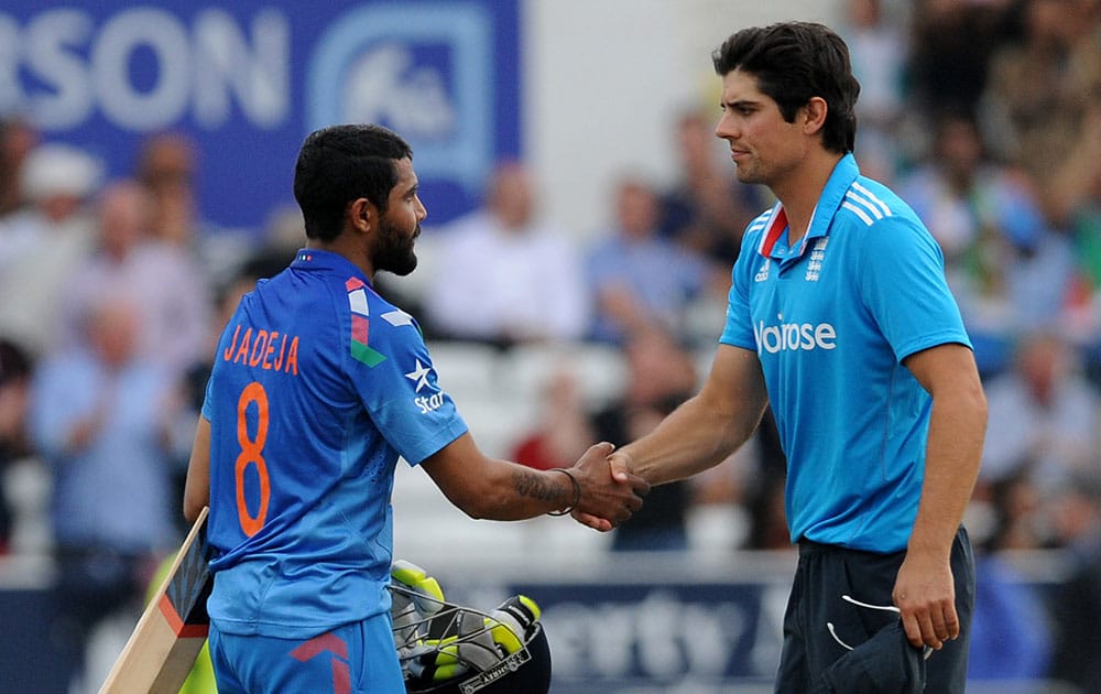 India's Ravindra Jadeja, left, shakes hands with England captain Alastair Cook after England beat India by 41 runs but lose the series 3-1 during the fifth One Day International match between England and India at Headingley cricket ground.