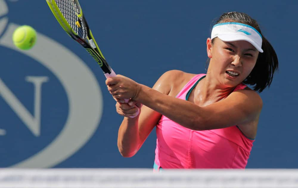 Peng Shuai, of China, returns a shot against Caroline Wozniacki, of Denmark, during the semifinals of the 2014 US Open tennis tournament.