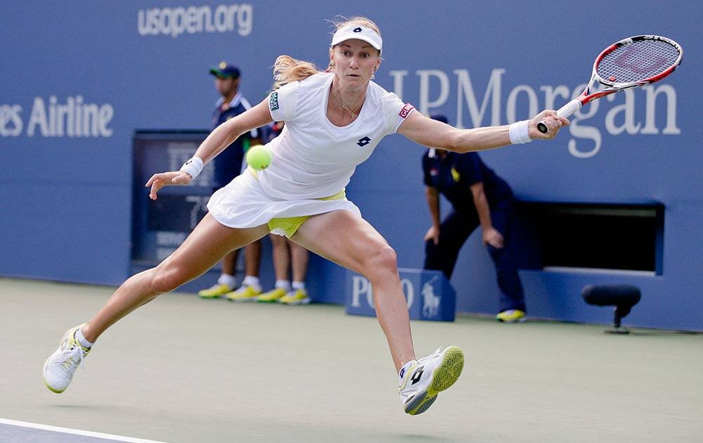 Ekaterina Makarova, of Russia, returns a shot against Serena Williams, of the United States, during the semifinals of the 2014 US Open tennis tournament.