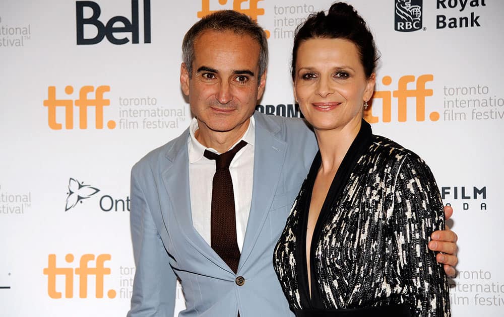 Olivier Assayas, left, writer/director of 'Clouds of Sils Maria,' poses with cast member Juliette Binoche at the premiere of the film at the 2014 Toronto International Film Festival at Princess of Wales Theatre.