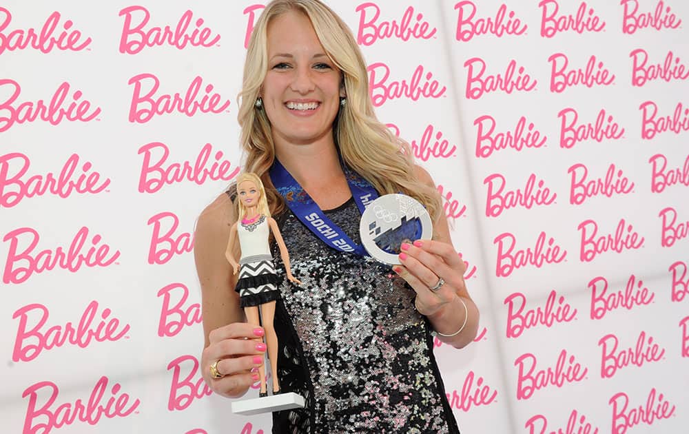 Olympic ice hockey silver medalist Brianne McLaughlin poses with Barbie at the Barbie and CFDA Fashion Lounge during New York Fashion Week.