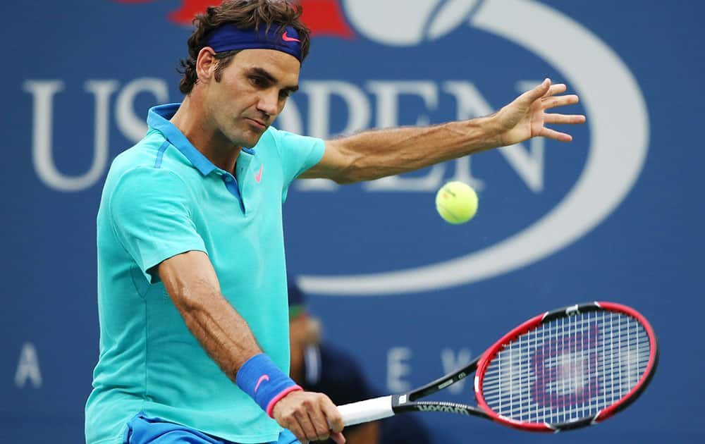 Roger Federer, of Switzerland, returns a shot against Marin Cilic, of Croatia, during the semifinals of the 2014 US Open tennis tournament.