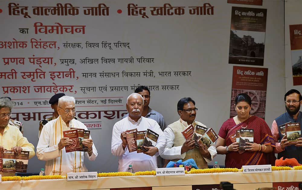 RSS chief Mohan Bhagwat along with Union Ministers Smriti Irani and Prakash Javadekar releasing three books by BJP leader Vijay Sonkar Shastri (unseen) during a function in New Delhi.