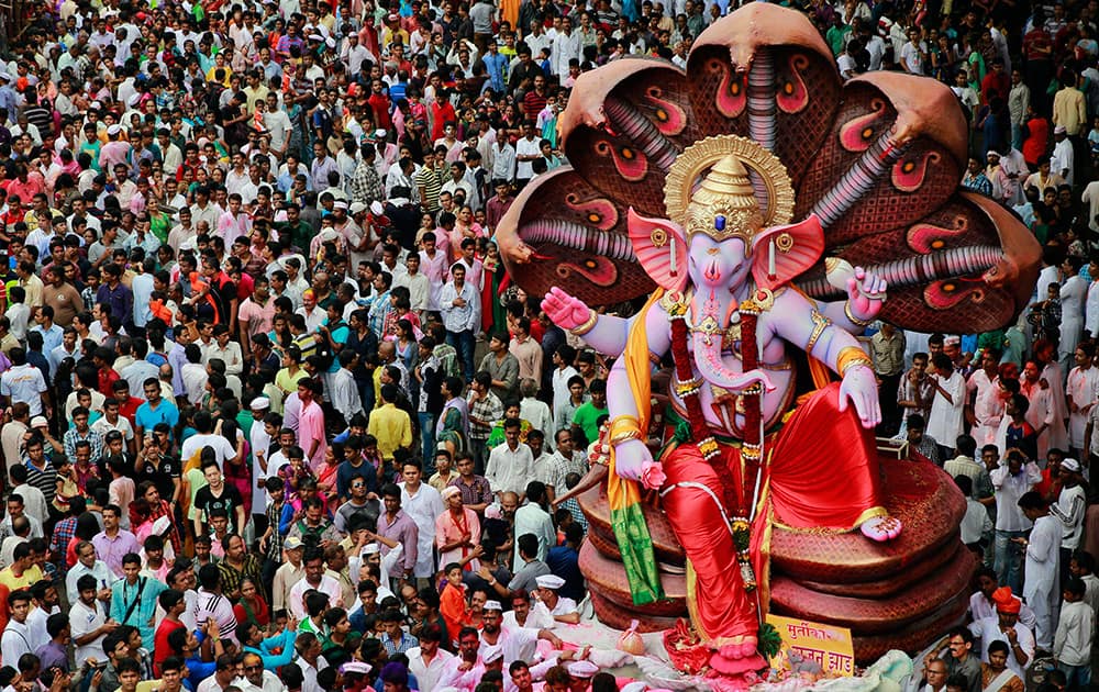 Hindu devotees take a procession with an idol of god 'Ganesha' to be immersed in the Arabian Sea, in Mumbai.