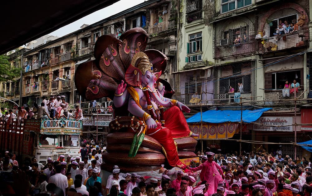 Hindu devotees mass around a large statue of the Hindu God Ganesha on the way to immerse it in the Arabian Sea on the final day of the festival of Ganesha Chaturthi in Mumbai.