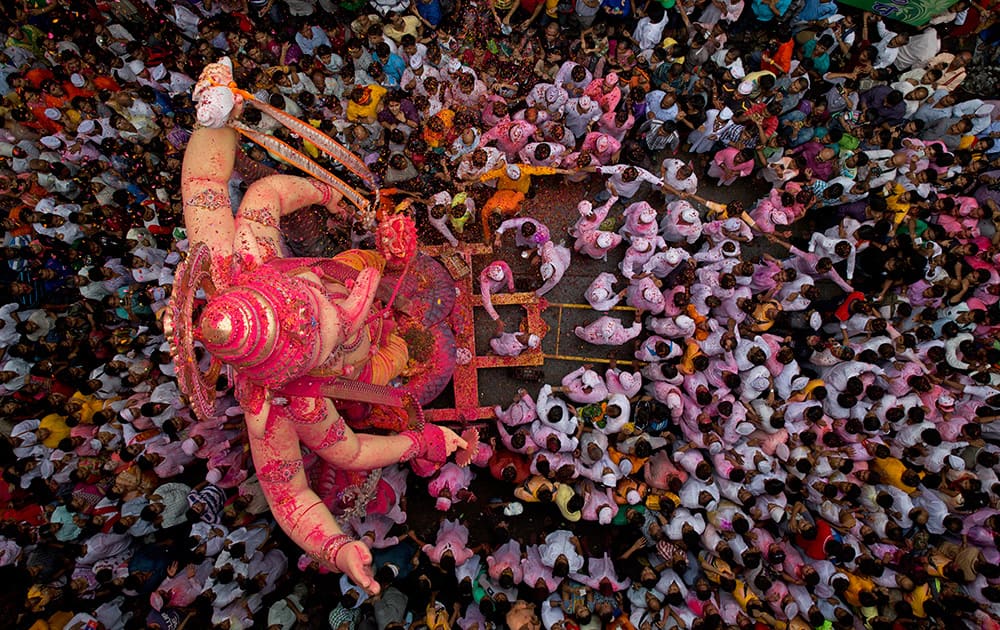 Hindu devotees mass around a large statue of the Hindu God Ganesha on the way to immerse it in the Arabian Sea on the final day of the festival of Ganesha Chaturthi in Mumbai.