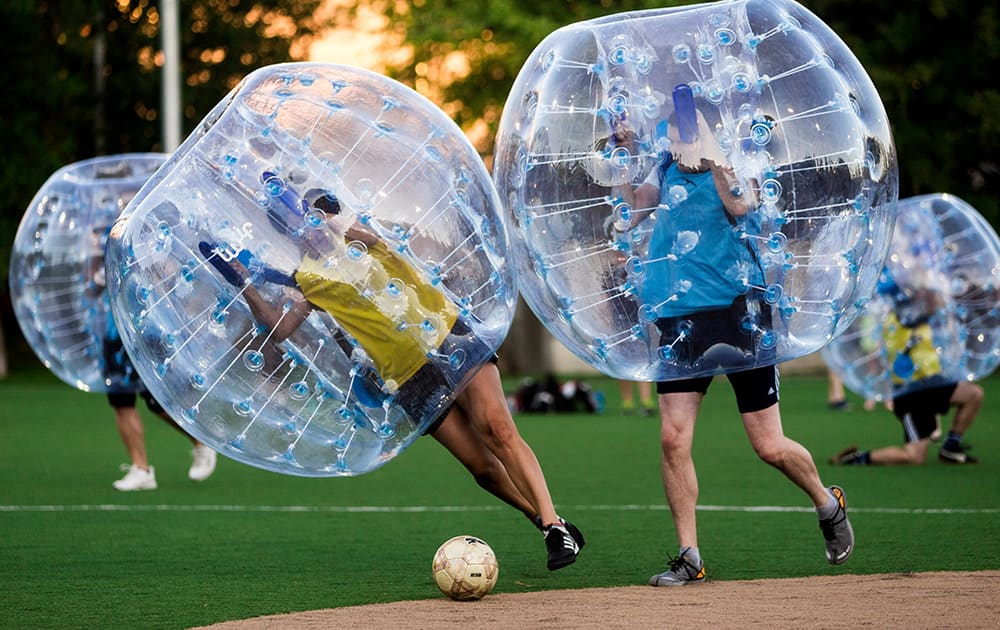 Players encased in bouncy, blue orbs push downfield during Seattle's first 'Bubble Futbol' tournament at Cal Anderson Park in the city's Capitol Hill neighborhood.