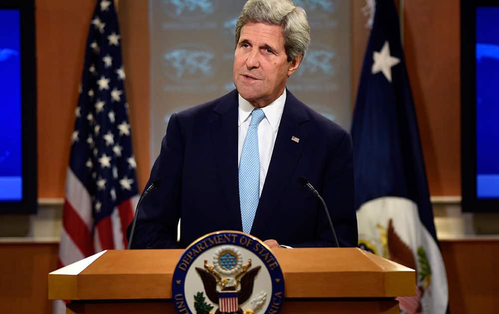 Secretary of State John Kerry speaks at State Department in Washington.  Kerry says Iraq has cleared a major milestone in the fight against the Islamic State militant group by forming a government that has pledged to ease sectarian tensions in the country.