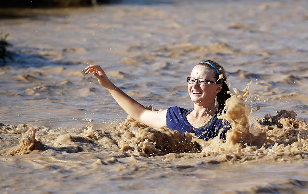 Jalea Blasingame falls into floodwater in Overton, Nev. The flood water came from heavy rain Monday that also washed out parts of Interstate 15.