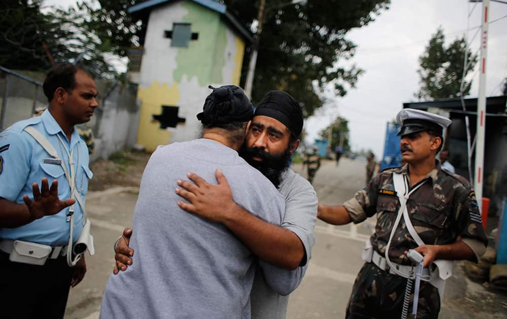 A flood victim hugs his relative after being rescued by the Indian Air Force in Srinagar, in Indian Kashmir.