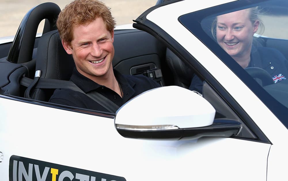 Britains Prince Harry sits in the drivers seat at the driving Challenge, the first event in the Invictus Games, in Gaydon, England.
