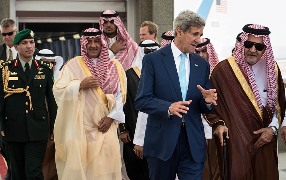 US Secretary of State John Kerry, second right, speaks with Saudi Foreign Minister Prince Saud al-Faisal, right, upon his arrival at the Royal Terminal of the King Abdulaziz International Airport in Jiddah, Saudi Arabia.