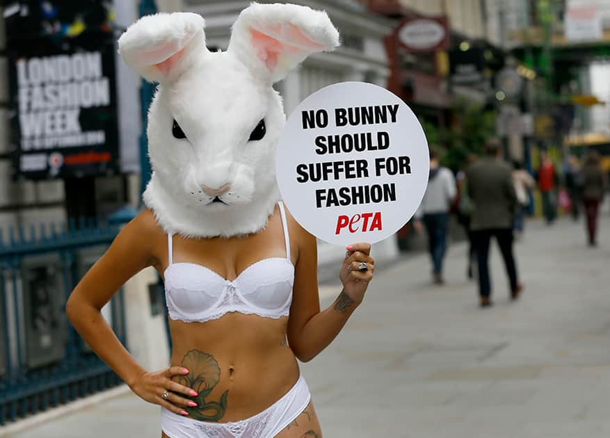 A model wears a rabbit head and holds a banner during a protest against the use of fur, outside Somerset House in London.