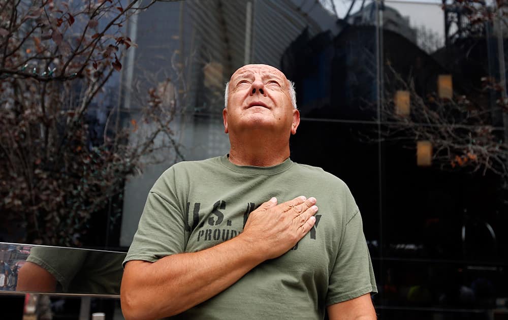 United States Navy veteran Richard Fill, of Easton, Penn., looks up at 1 World Trade Center during a moment of silence on the 13th anniversary of the Sept. 11, 2001 attacks in New York.