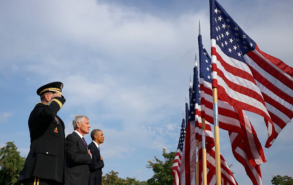 President Barack Obama, Defense Secretary Chuck Hagel, and Joint Chiefs Chairman Gen. Martin Dempsey participate in a ceremony at the Pentagon to mark the 13th anniversary of the 9/11 attacks.