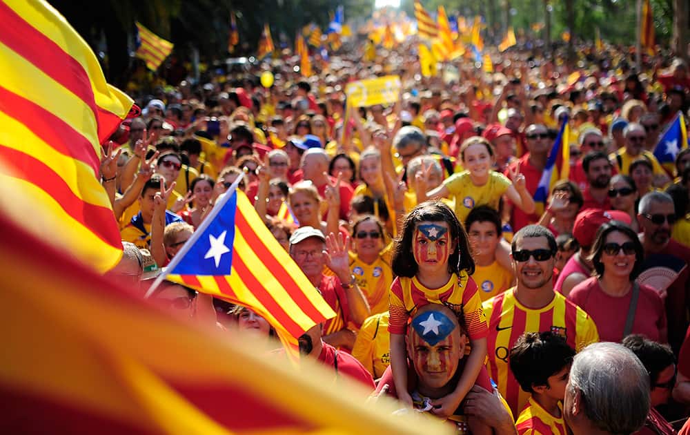 People wave 'estelada' flags, that symbolize Catalonia's independence, during a demonstration calling for the independence of Catalonia in Barcelona, Spain.