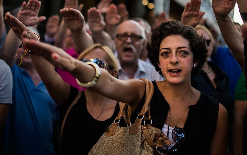 Far right wing supporters salute the fascist anthem during an act against the independence of Catalonia outside a Catalan cultural centre in Madrid, Spain