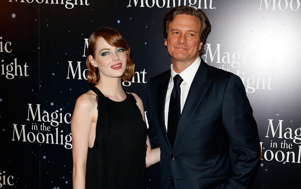 Actors Emma Stone, left, and Colin Firth pose during a photocall prior to the screening of 'Magic in The Moonlight' directed by Woody Allen presented in Paris.